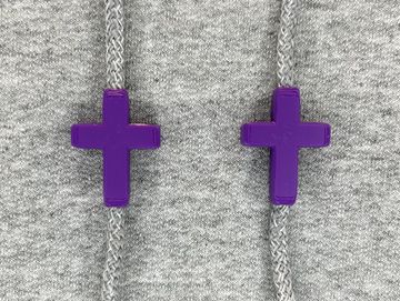 Purple cross charms on sweatshirt drawstrings