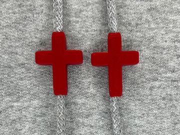 Crimson red cross charms on sweatshirt drawstrings
