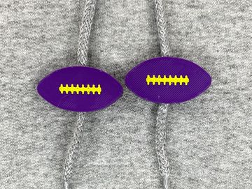 Purple and gold football sweatshirt charms on a grey sweatshirt