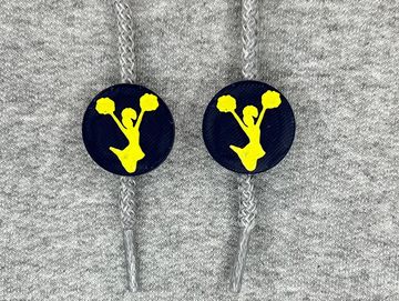 Silhouetted cheerleader charm in navy blue and gold on sweatshirt drawstring.