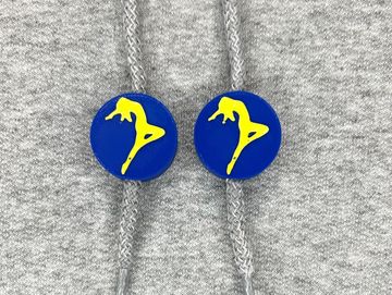Silhouetted dancer charm in dark blue and gold on sweatshirt drawstring.