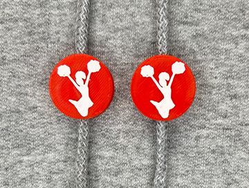 Silhouetted dance charm in red and white on sweatshirt drawstring.