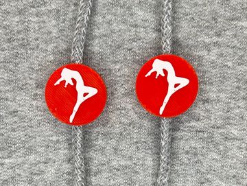 Silhouetted dance charm in red and white on sweatshirt drawstring.