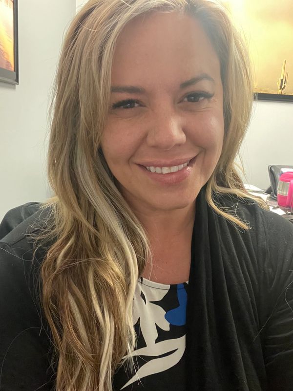 Reiki Practitioner, smiling woman with long blonde hair 