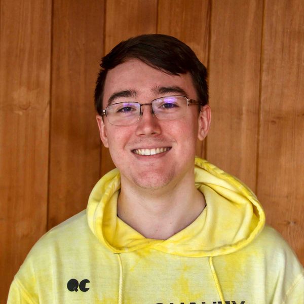 Evan Strain smiling in front of the church headshot photo 