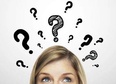 A person thinking with question marks over head.