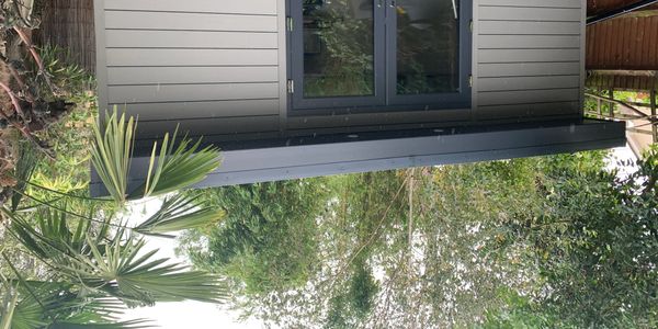 Garden office with patio doors and composite cladding and rubber roof
