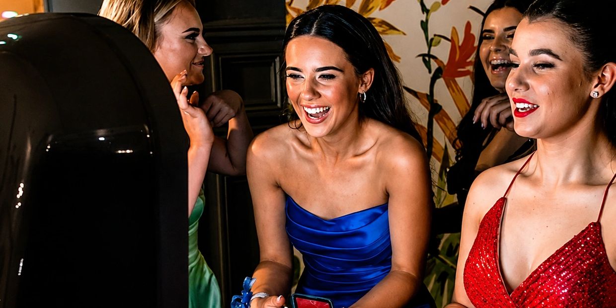 Group of young women in formal dresses enjoying a moment.