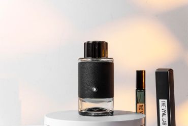Two perfume bottles on a white surface.