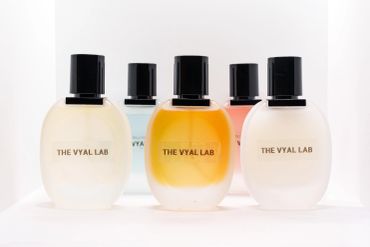 Five elegant perfume bottles with black caps from THE VYAL LAB.
