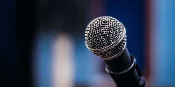 A microphone on a stand in a radio studio