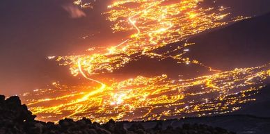 A photo taken at night of a city all lit up showing the electricity network