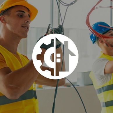 Electricians working on wiring in construction site.