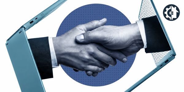 Handshake emerging from laptop screens symbolizing online agreement.