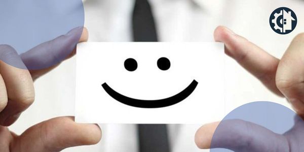 Hands holding a card with a smiley face.