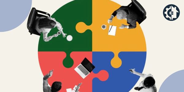 People working together around a colorful puzzle table.