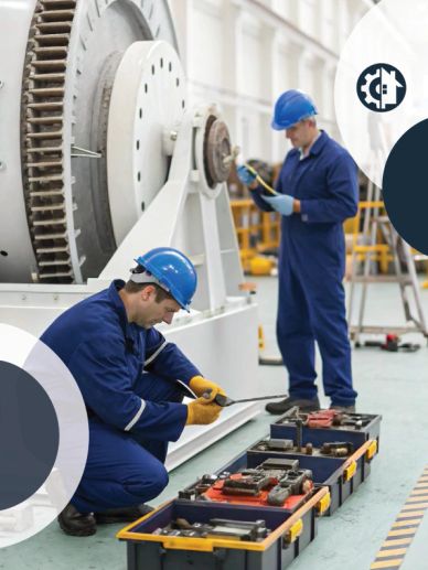 Two engineers inspecting turbine equipment in a factory.