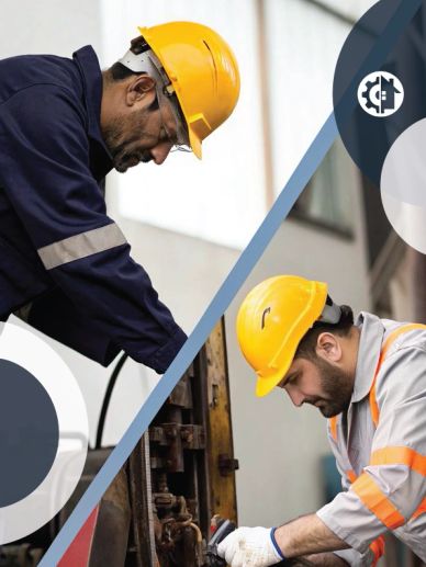 Two construction workers in safety gear working attentively.