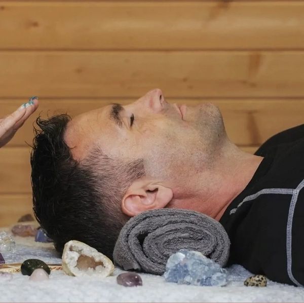 Male receiving reiki at crown chakra