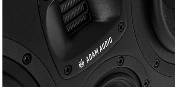 Close-up of a black ADAM Audio speaker with detailed components.