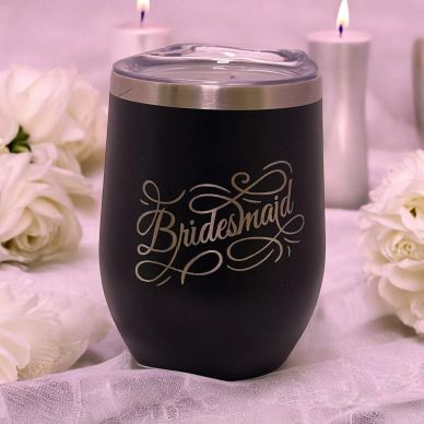 Black tumbler with 'Bridesmaid' text surrounded by white flowers and candles.