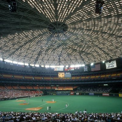 Indoor baseball stadium with a closed dome roof.