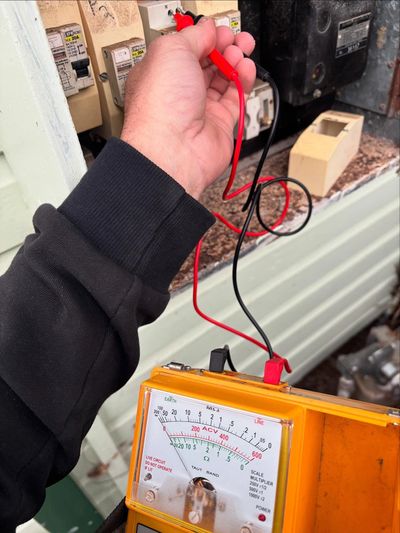 NextPhase Electrical Solutions Electrician testing meter in residential switchboard in Newcastle, NS