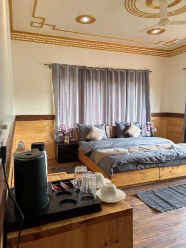 Cozy bedroom with wooden furniture and soft lighting.