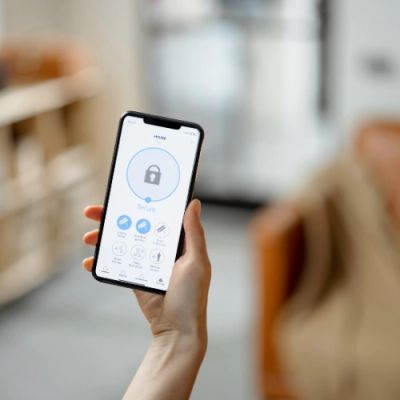 Person holding a smartphone with a security app open.