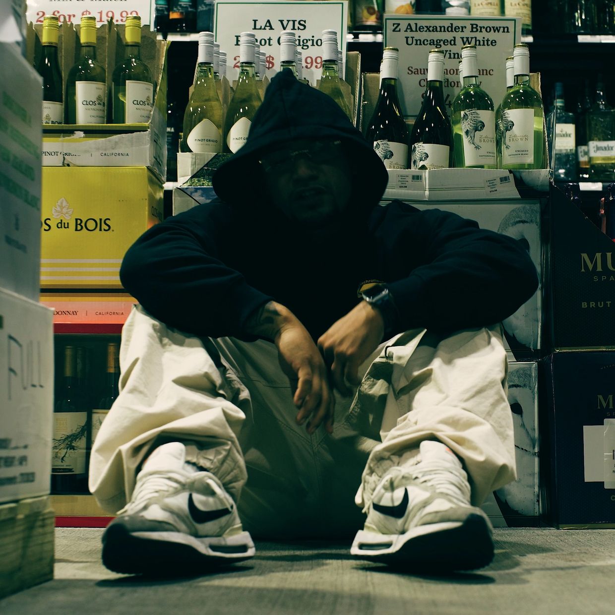 Bleeze sit on the floor inside a liquor store