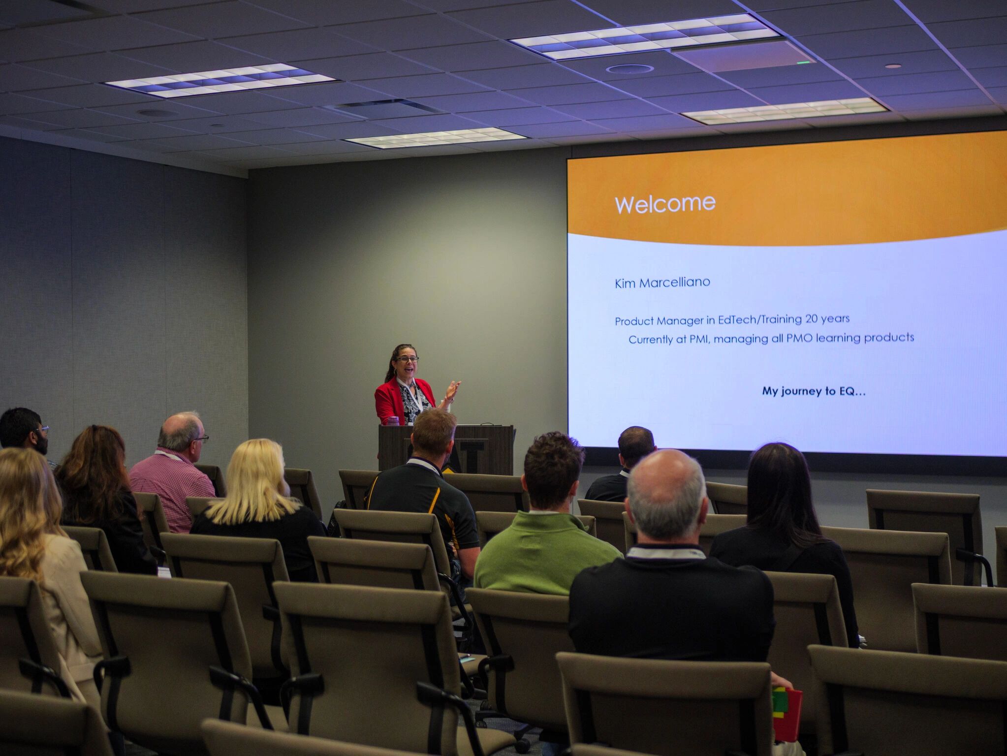 A woman presents to an audience about her journey to emotional intelligence.