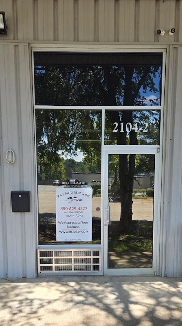 Glass door entrance with sign for R. S. Auto Repair Inc.