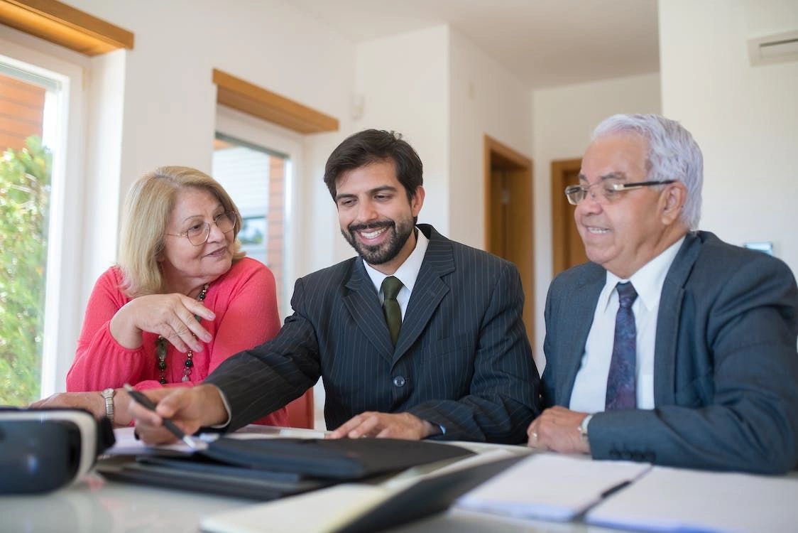 An old couple talking to a real estate agent in Camp Hill, PA