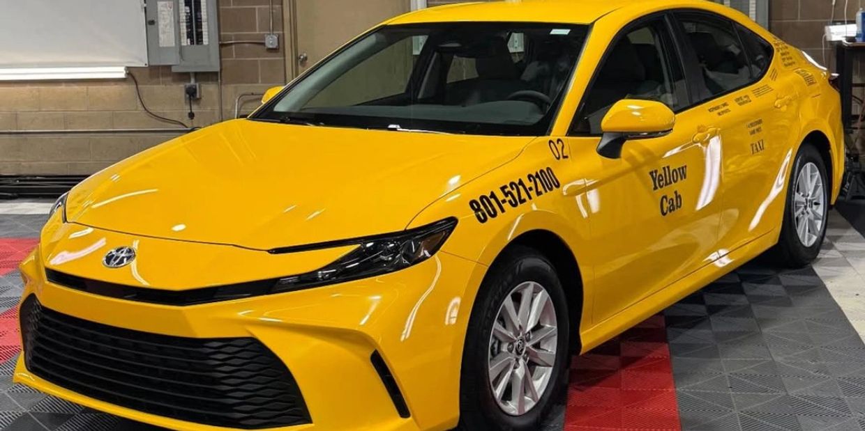Vinyl Lettering on the side of a taxi cap that has been wrapped yellow in salt lake city utah