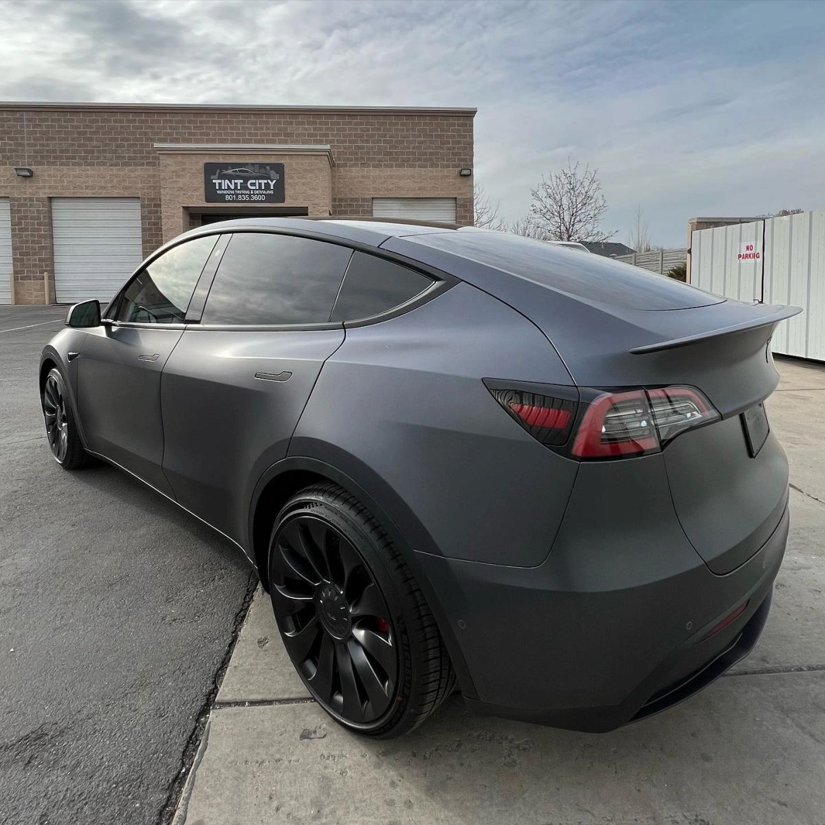 A Tesla Model Y in its satin gunmetal finish at Tint Citi