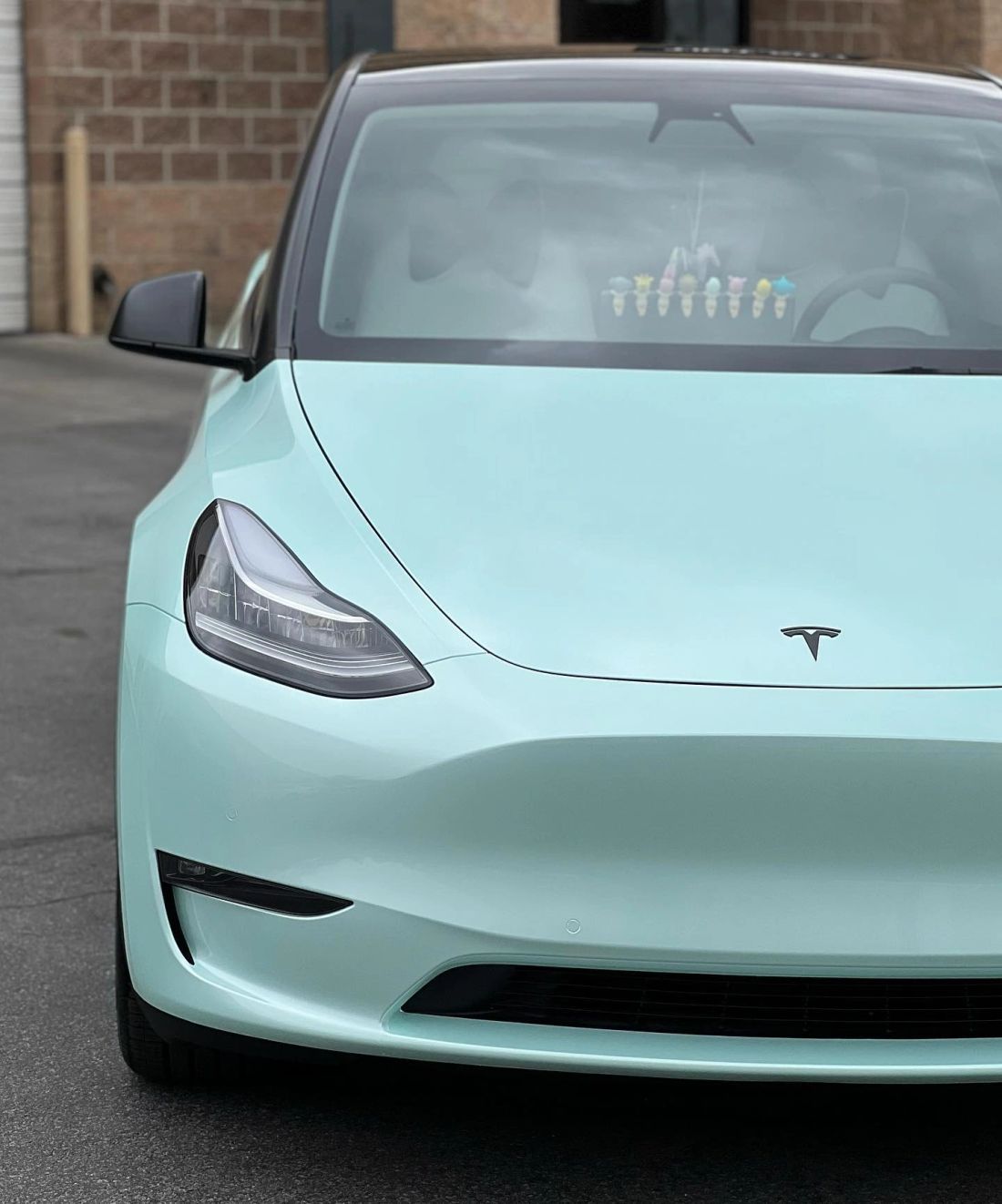Tesla Model 3 with partial paint protection film on the bumper, mirrors, hood, and headlights
