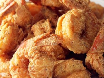 Close-up of crispy fried shrimp piled together.