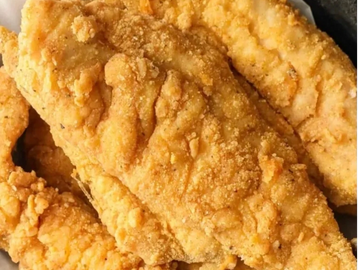 Close-up of crispy fried fish fillets with golden breading.