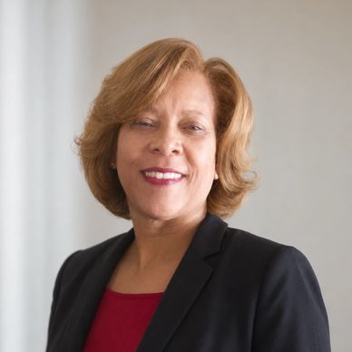 Professional woman smiling in business attire.