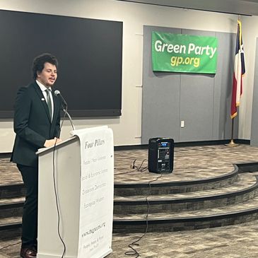 Man speaking at a Green Party event.