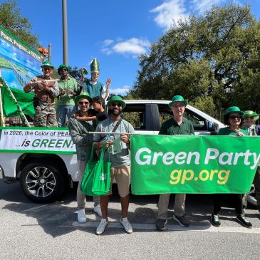 Group promoting the Green Party at an outdoor event.
