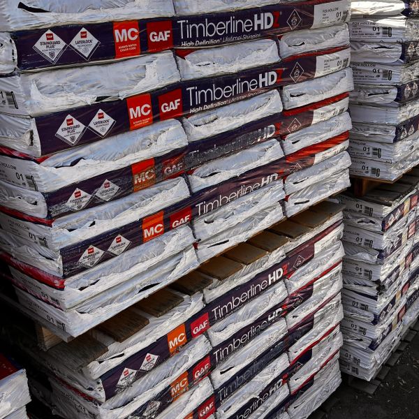 Pallets of GAF Timberline HD roofing shingles stacked.