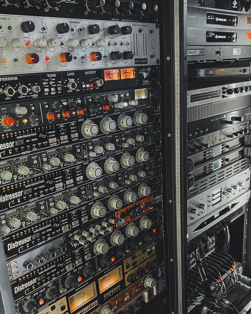 Professional audio rack with compressors and equalizers for sound mixing.