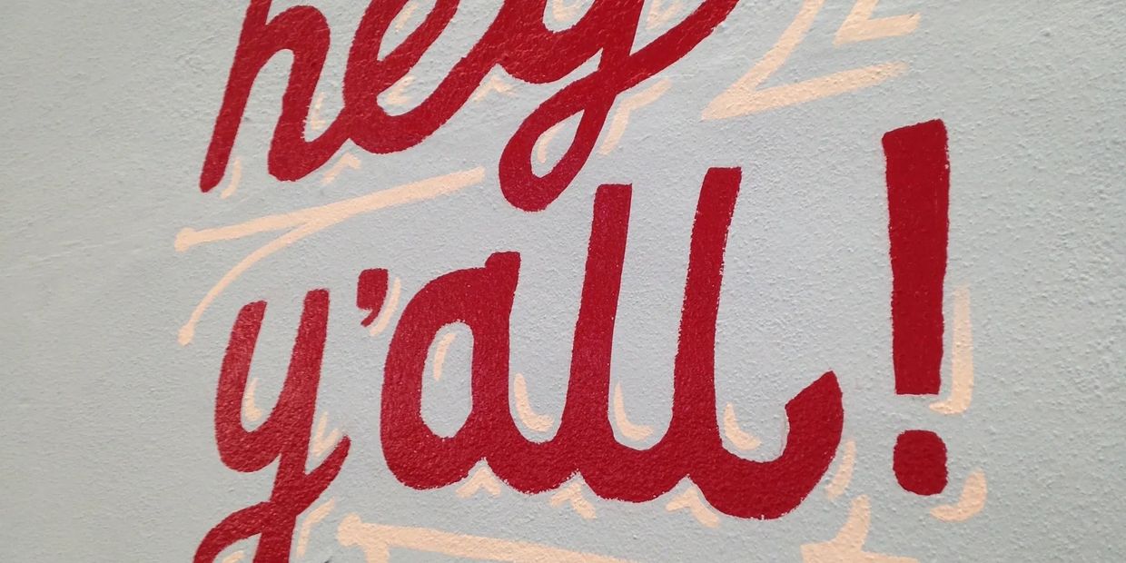 Red graffiti saying "hey y'all!" with a heart above it.