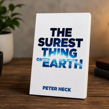 Book titled 'The Surest Thing on Earth' by Peter Heck on a wooden table.
