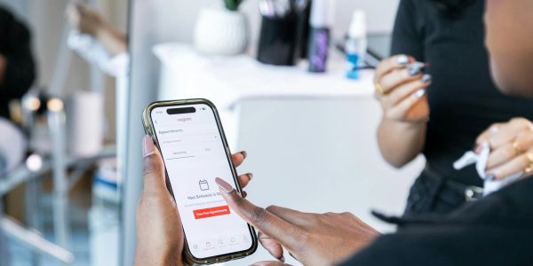Person booking appointment on smartphone.