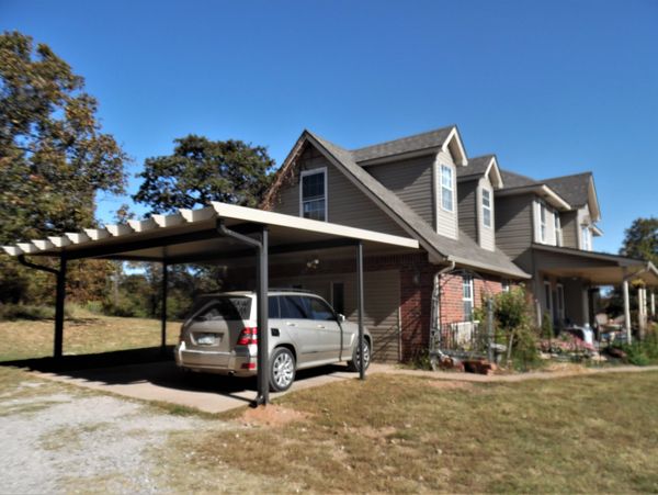 20ft x 20ft attached rolled formed aluminum carport with Santa-fe trim option Clay/bronze in color. 