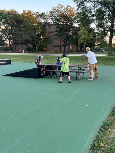 Coach Erik Palmer working with beginner skateboard students – SK8 Lessons Chicago