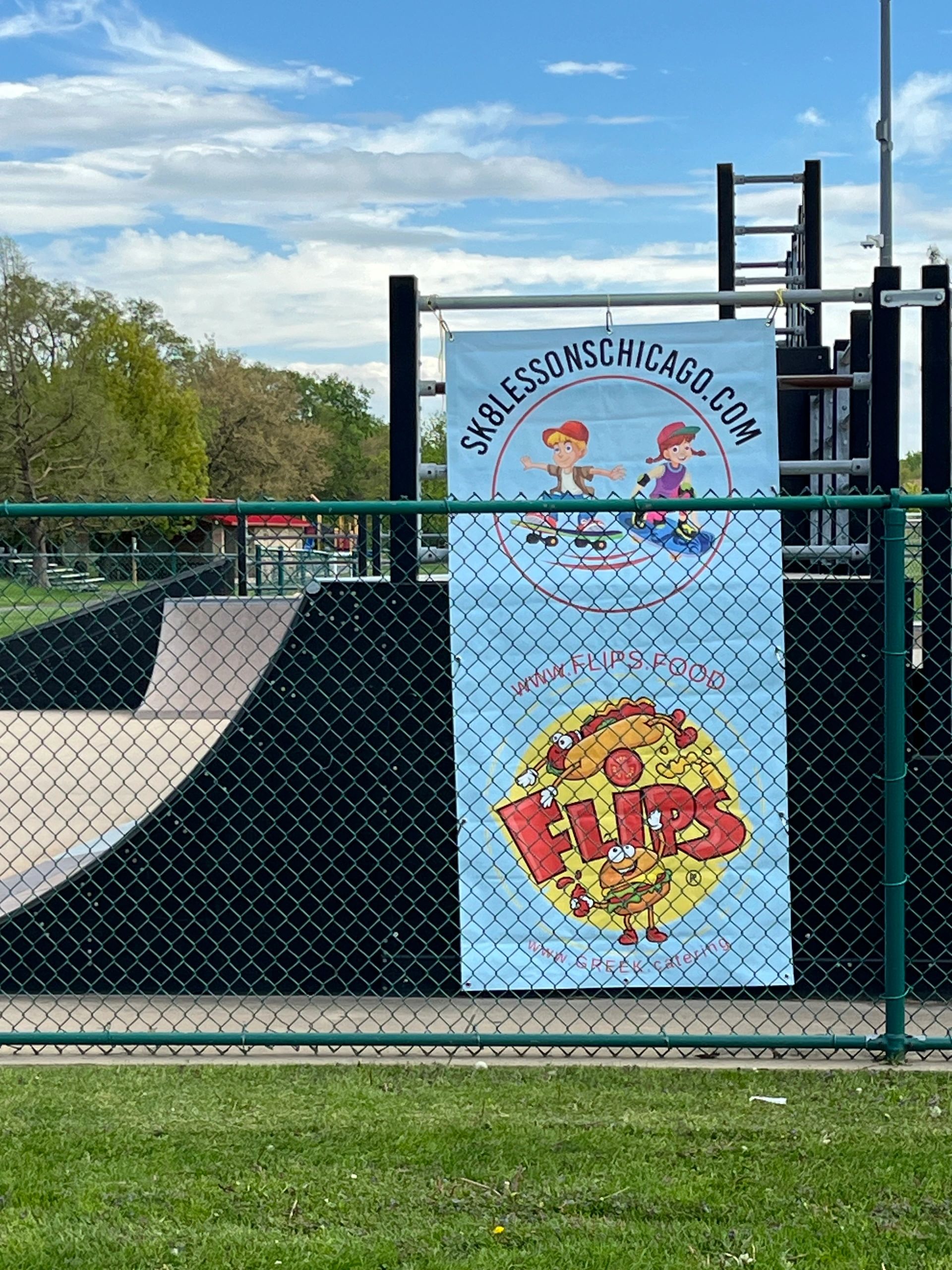 Sk8 Lessons Chicago banner at a skatepark with Flip’s Beef sponsor logo during youth programs.