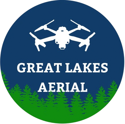 Great Lakes Aerial logo with drone flying above pine trees